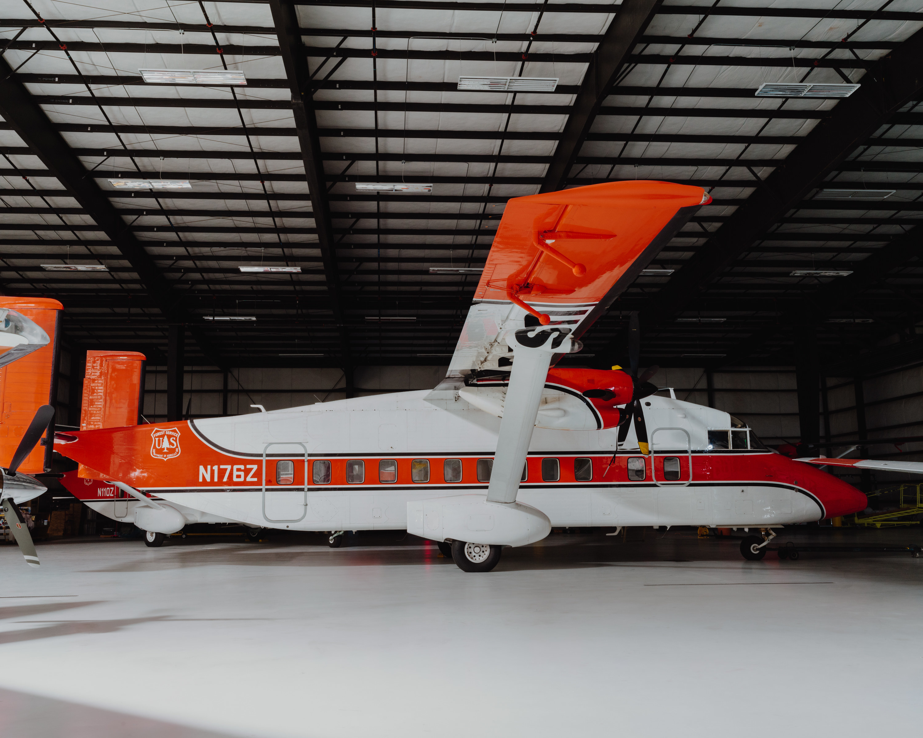 A white and orange plane in a hangar