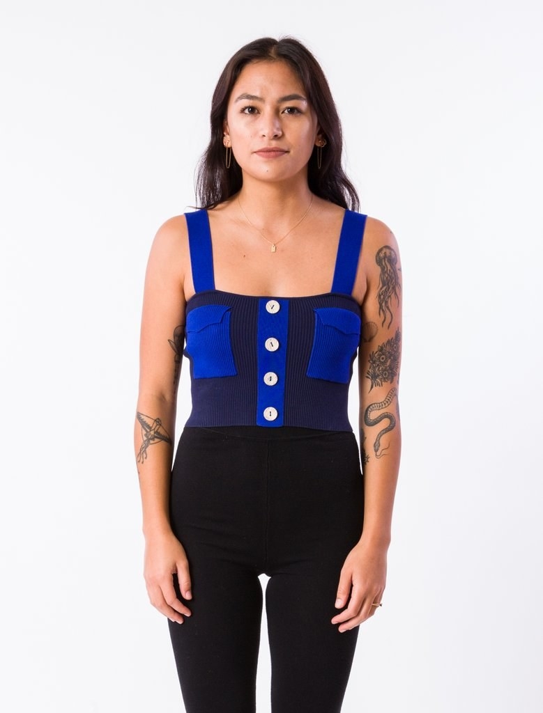 thick strapped tank with two front pockets and buttons down the center