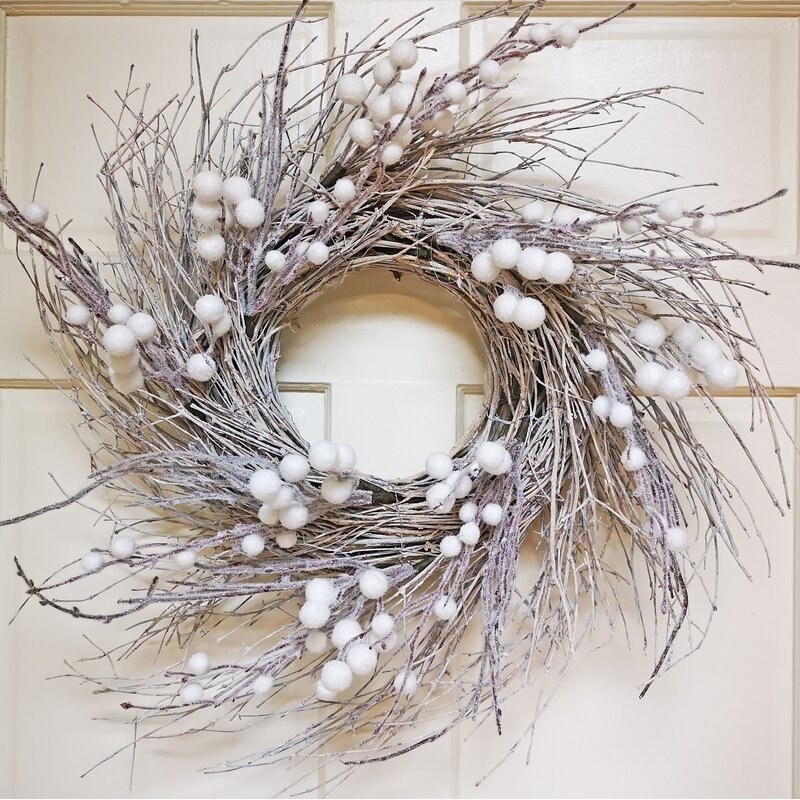 Frosted twig wreath with white poms on door