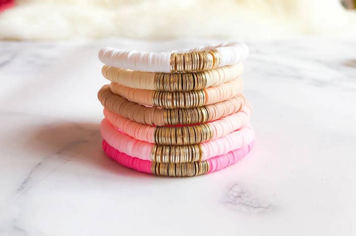 A stack of beaded bracelets in shades of pink.