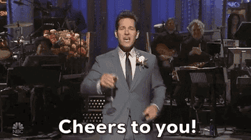 Paul Rudd stands on stage and raises a champagne glass while saying &quot;Cheers to you!&quot; on &quot;Saturday Night Live&quot;
