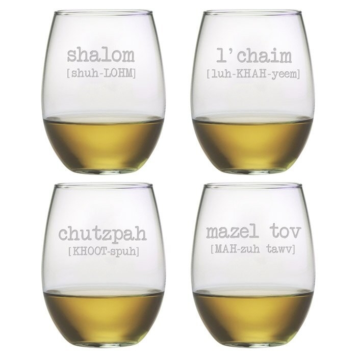 4 stemless wine glasses with hebrew etched words on them, white wine inside