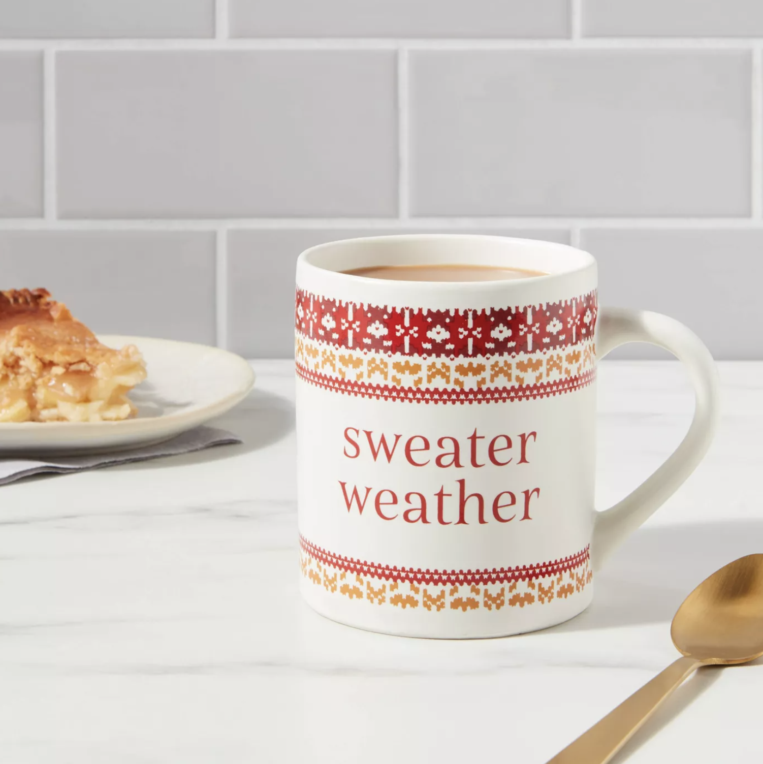 the sweater weather mug on a counter