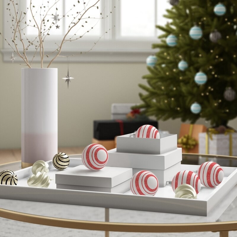 White ornaments with red stripes on white boxes