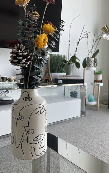 Reviewer photo of the vase holding some dried flowers on a living room table