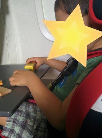 reviewer's child playing with the blocks on a plane