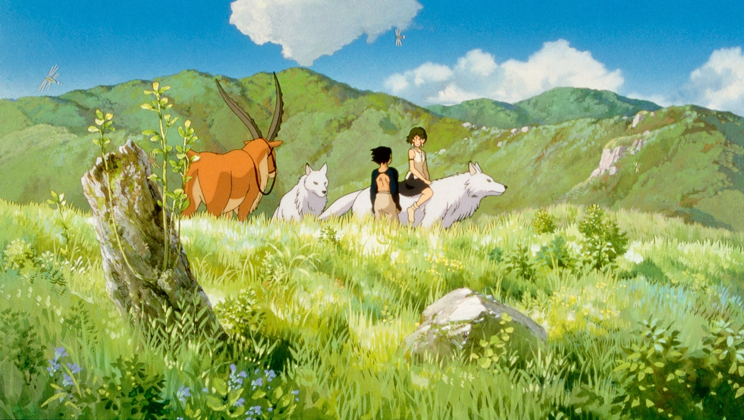 Prince Ashitaka (voice: Billy Crudup), San (voice: Claire Danes), Moro (voice: Gillian Anderson) standing in a green field