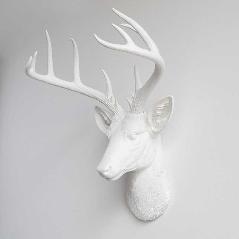An image of a large deer&#x27;s head statue made of resin