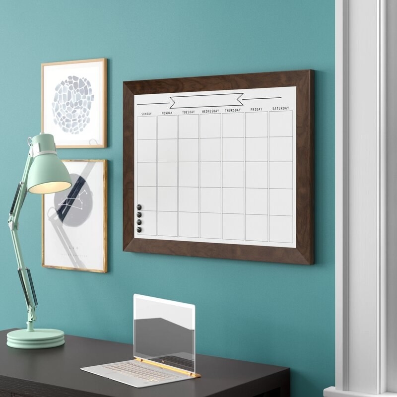 A image of a wall mounted calendar dry erase board
