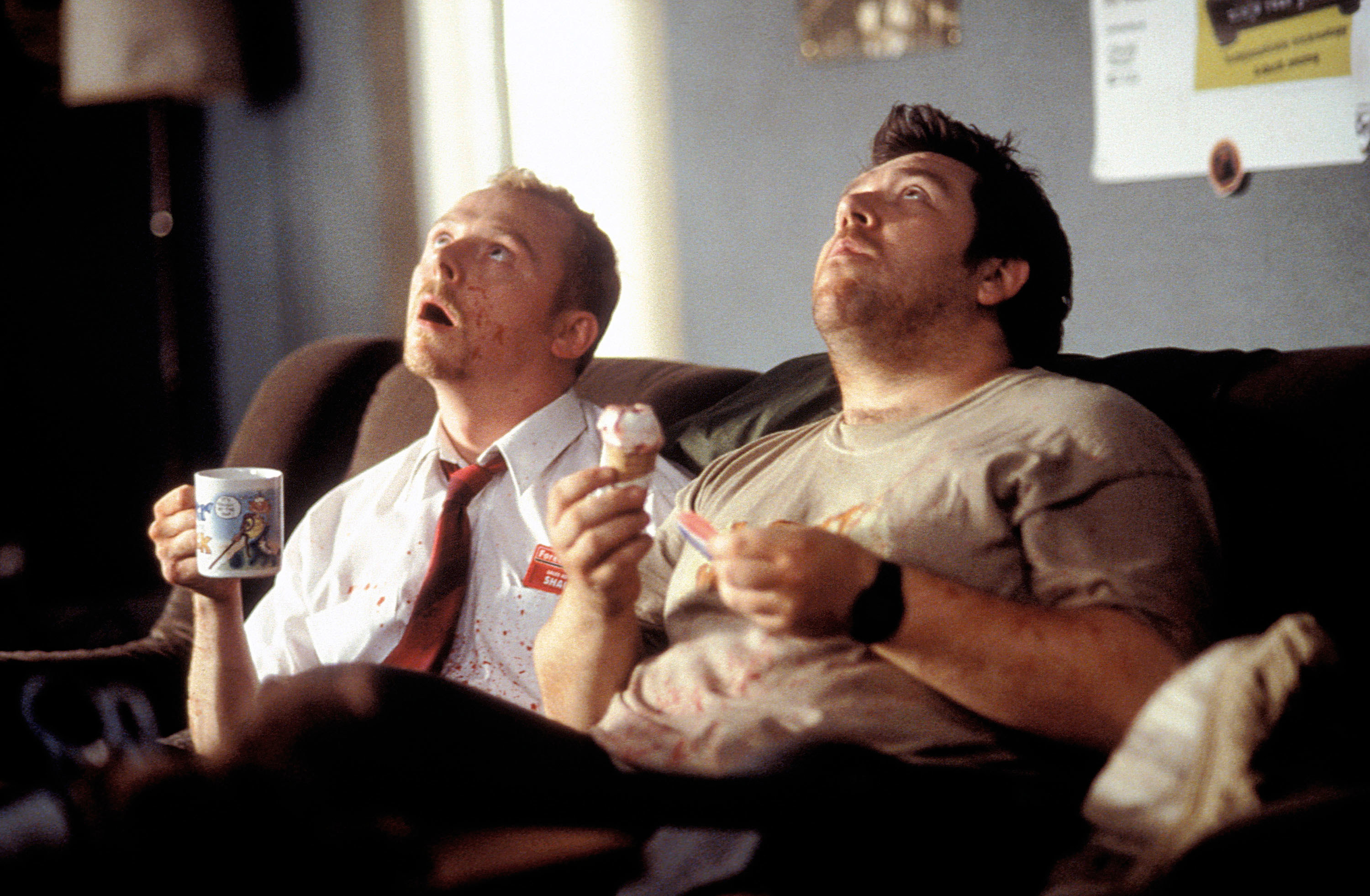 Simon Pegg, Nick Frost sitting on a sofa looking up