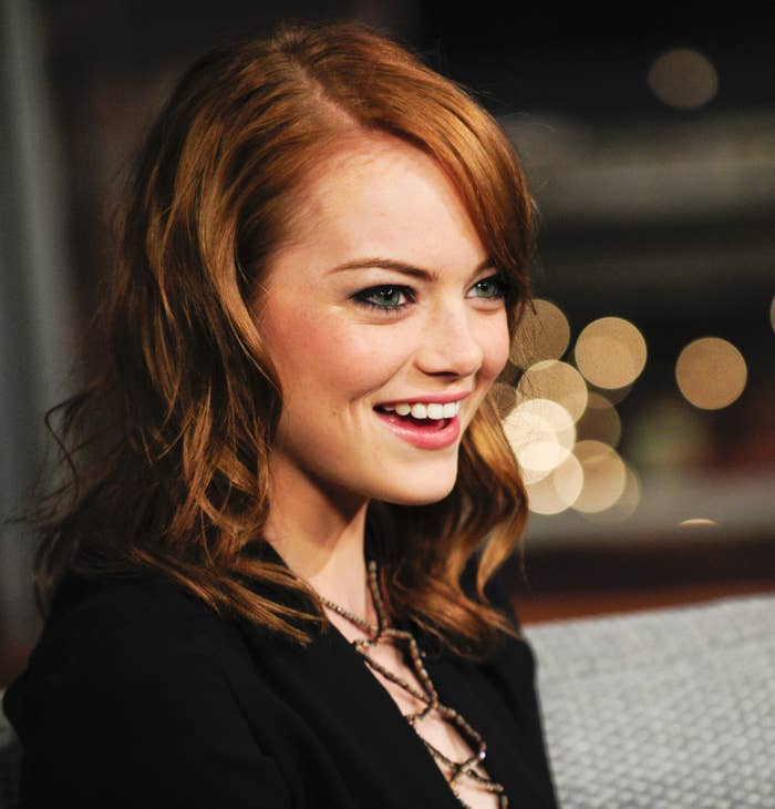 A headshot of a smiling Emma Stone