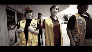 group of people wearing volunteer vests