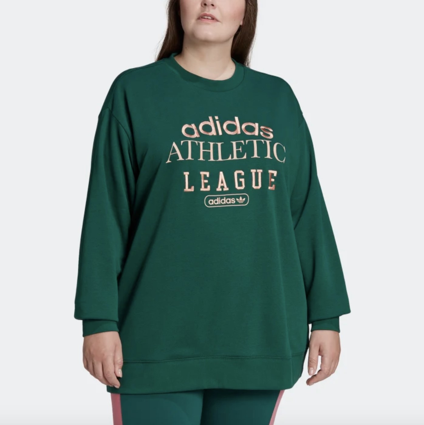 An adult wears the green crewneck with light stitching