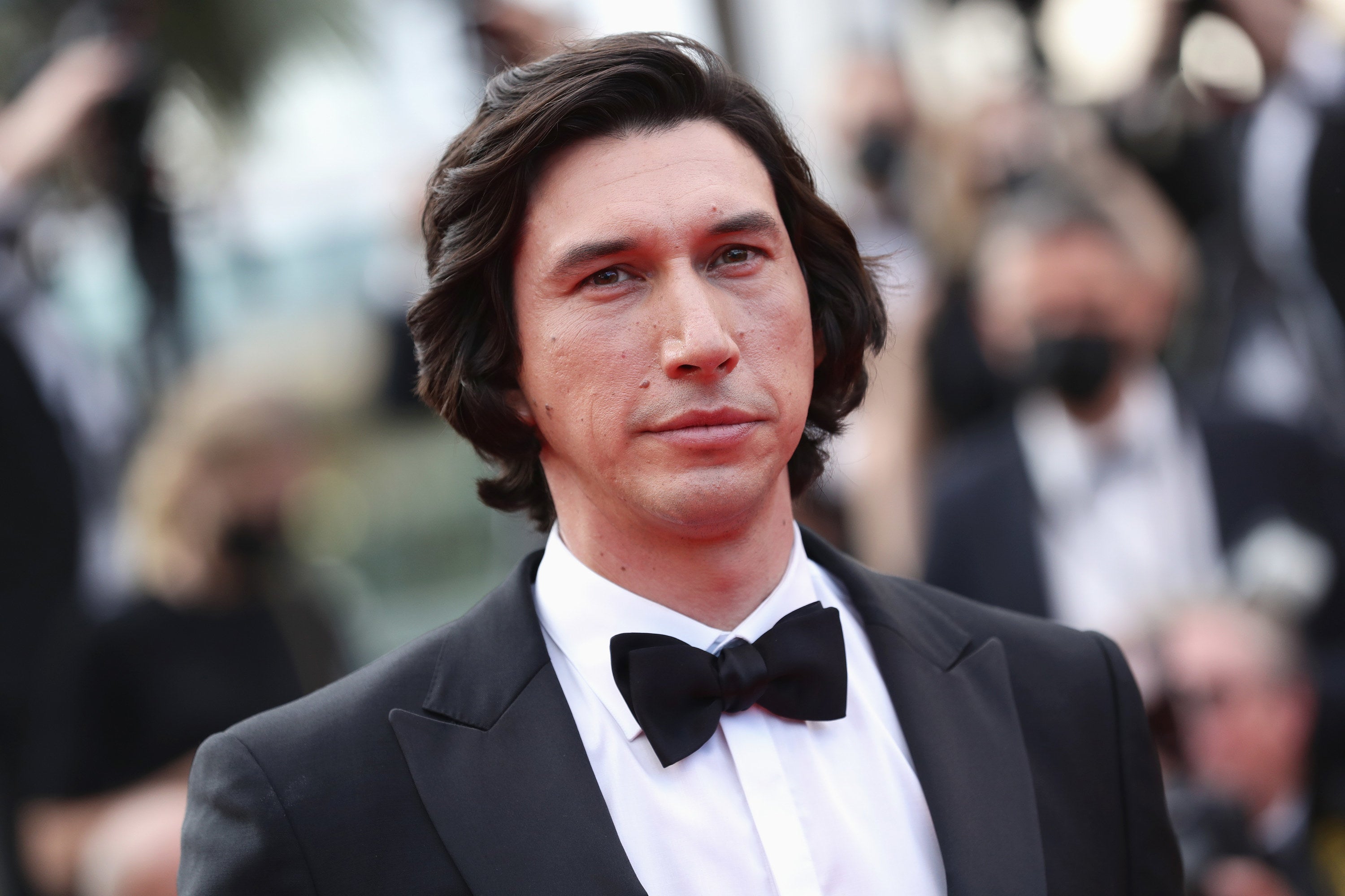 Adam Driver smiling and looking into the camera