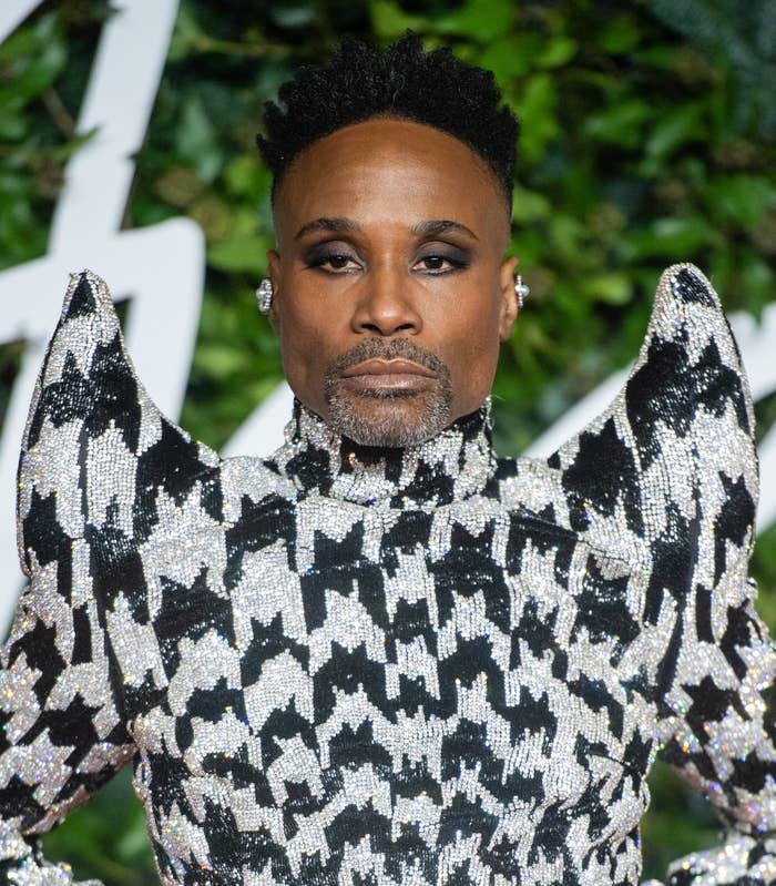 Billy Porter in a black and white glittery outfit, looking into the camera