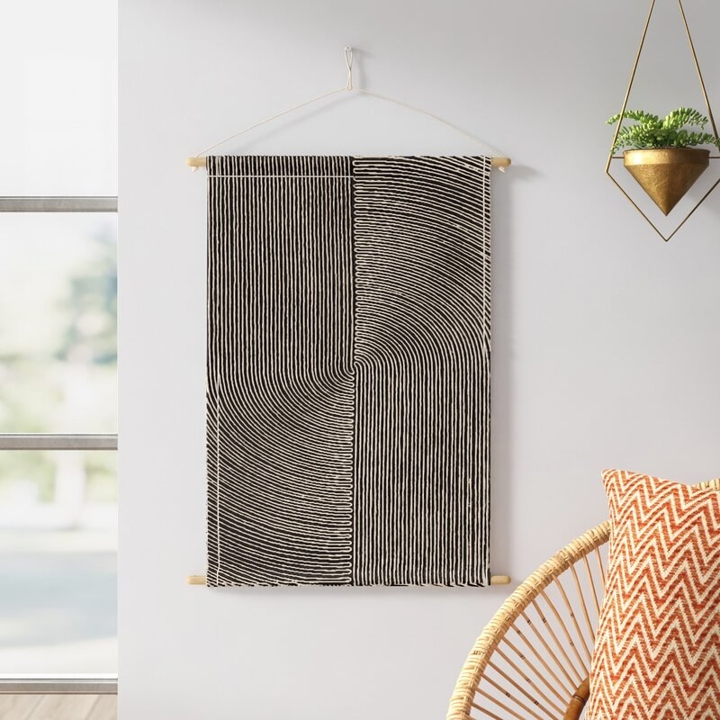 An image of a grey cotton wall hanging tapestry