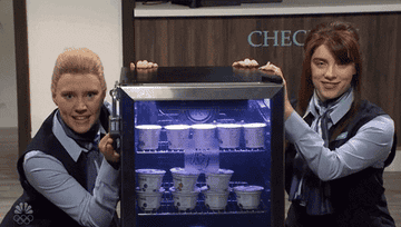 GIF of Kate and Billie beside a small refrigerator display