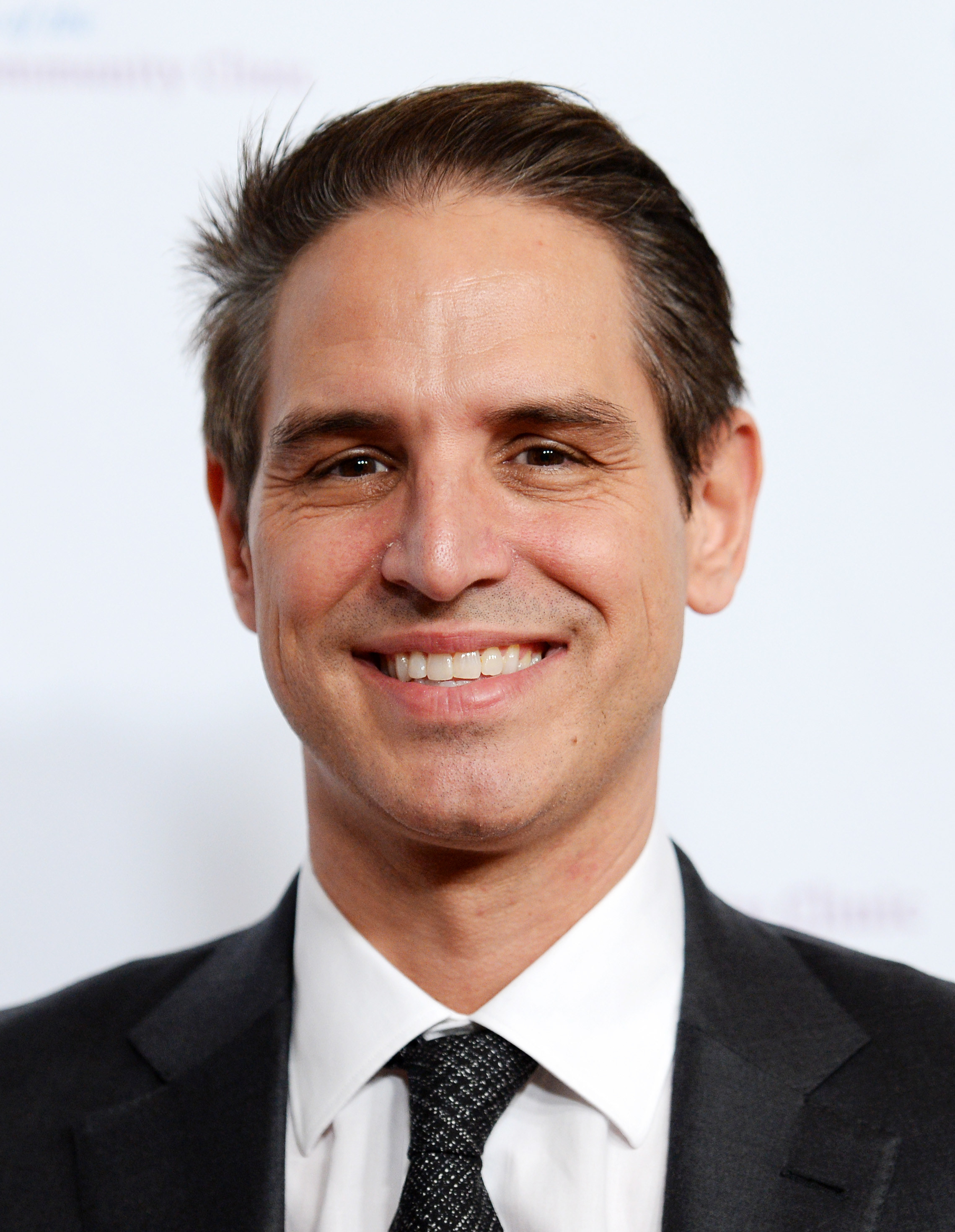 Greg Berlanti looking into the camera and smiling
