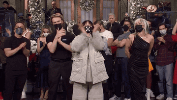 The SNL cast and guests, including Miley and Billie, wearing masks  and clapping