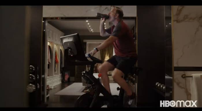 Chris Noth cycling while drinking a beverage
