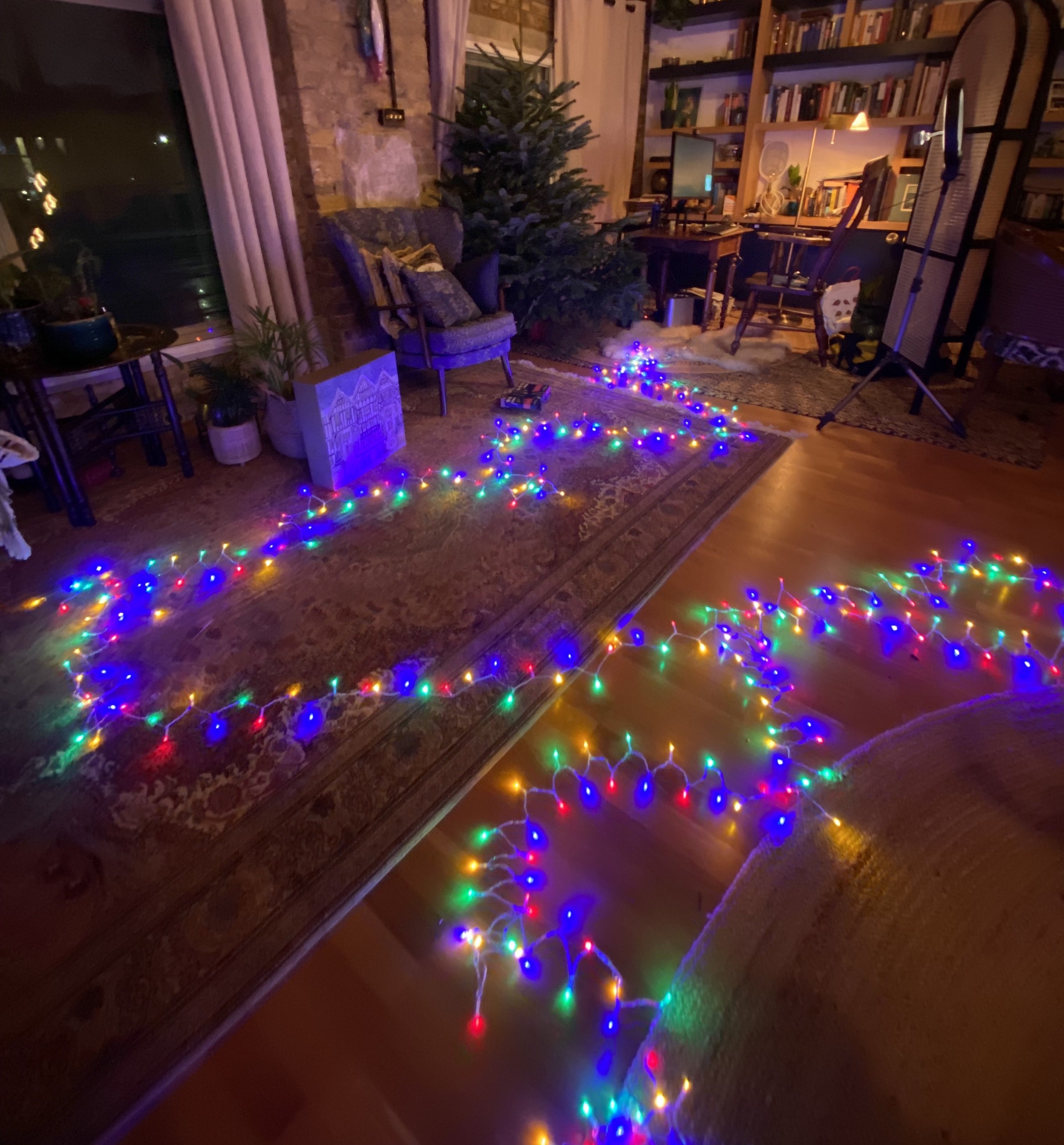 a large string of lit christmas lights laid out on the floor
