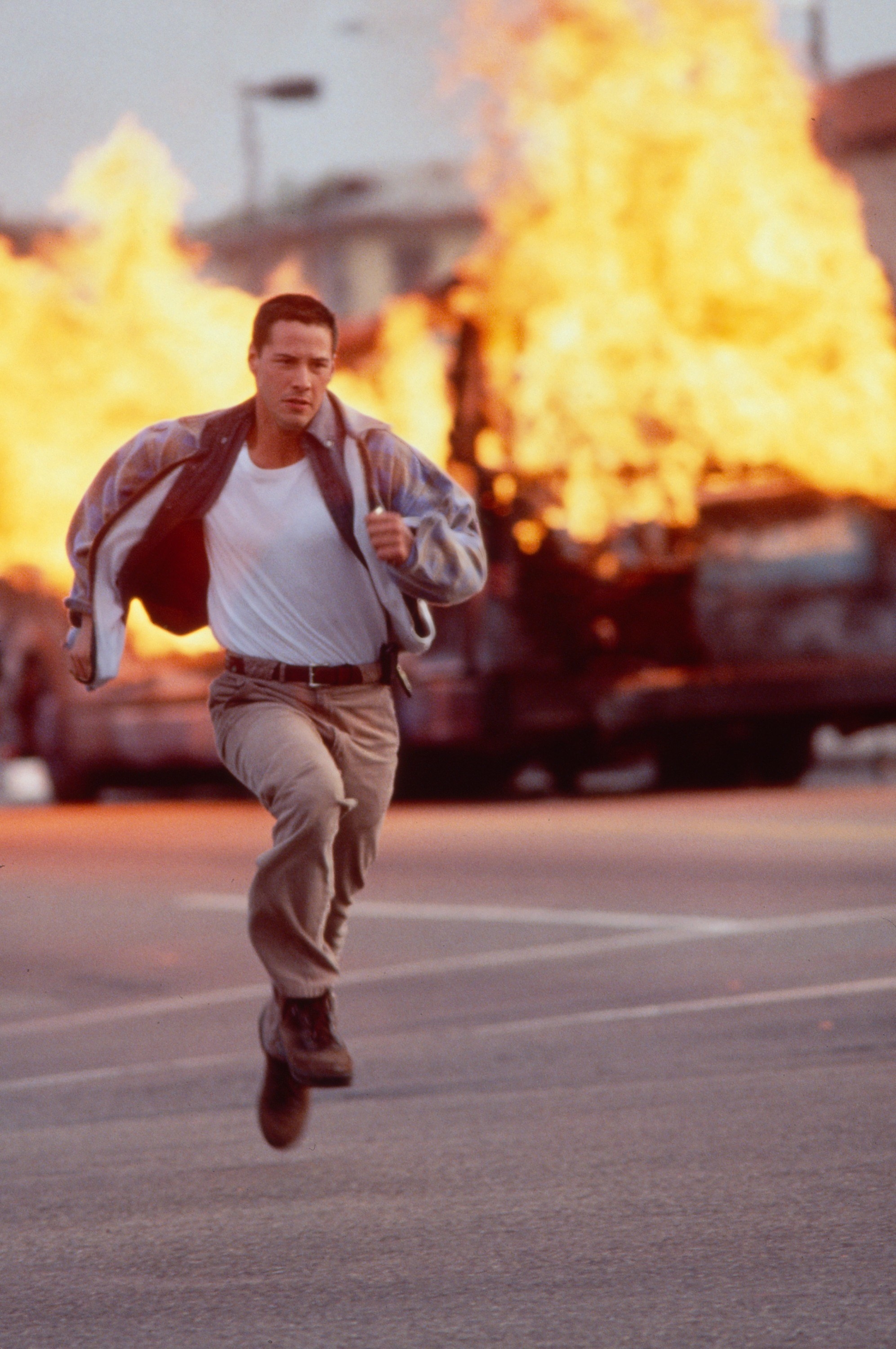 Reeves runs away from an explosion