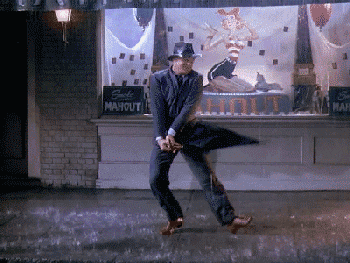 a man twirling his umbrella in the rain