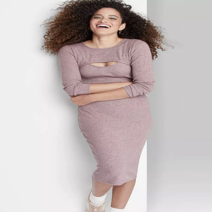 front view of model wearing the dress in grey/pink, showing off the shrug as well