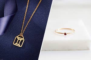On the left is a zodiac symbol necklace and on the right is a simple golden ring with a garnet stone.