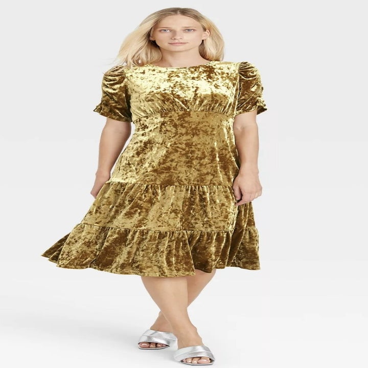 front view of model wearing the dress in gold
