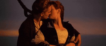 jack and rose kissing at the helm of titanic