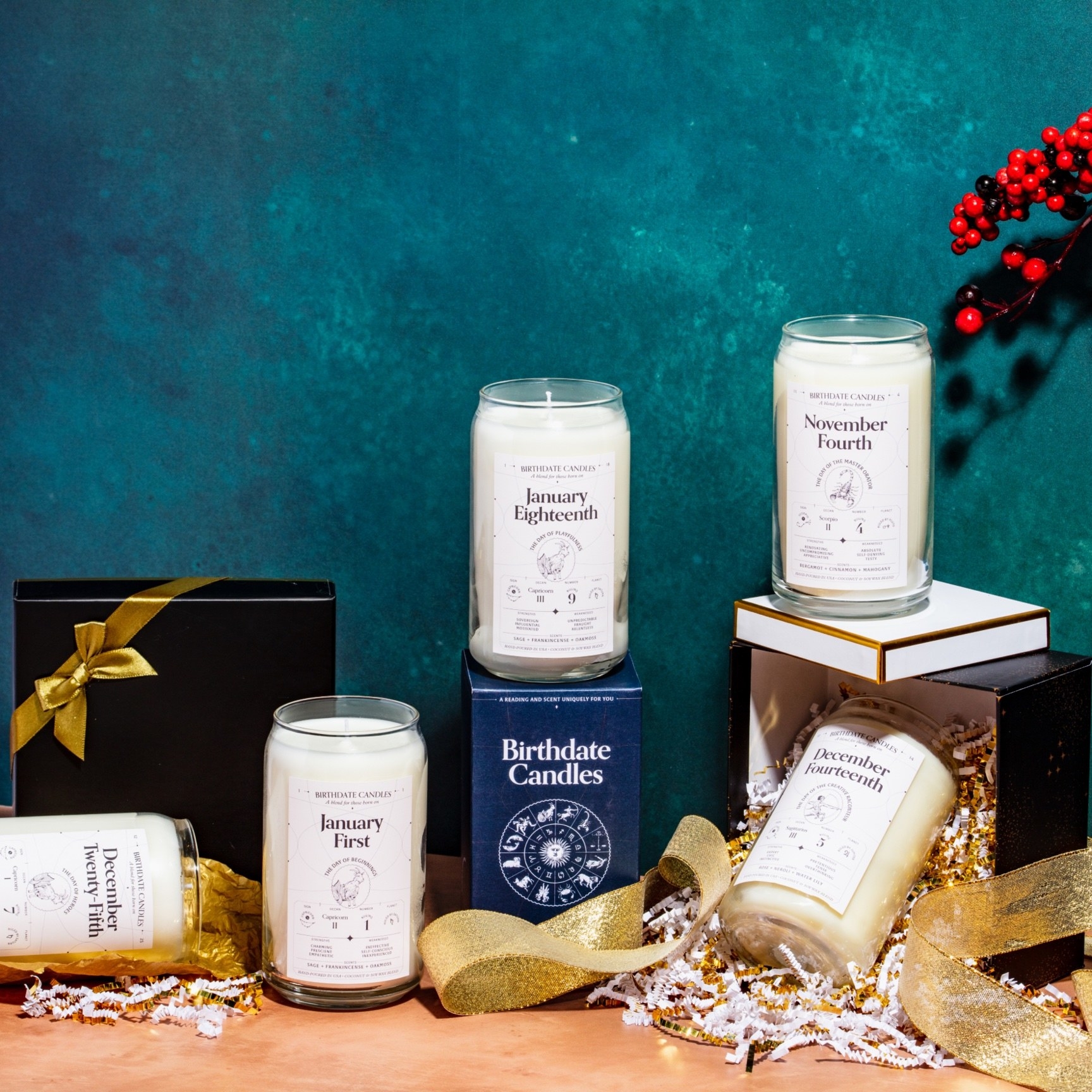 Five of the birthdate candles arranged around various gift boxes and packaging