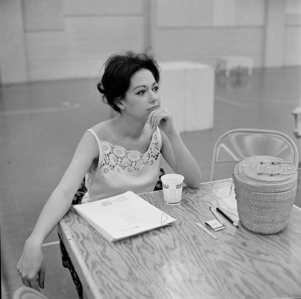 Rita sitting at a table with a script