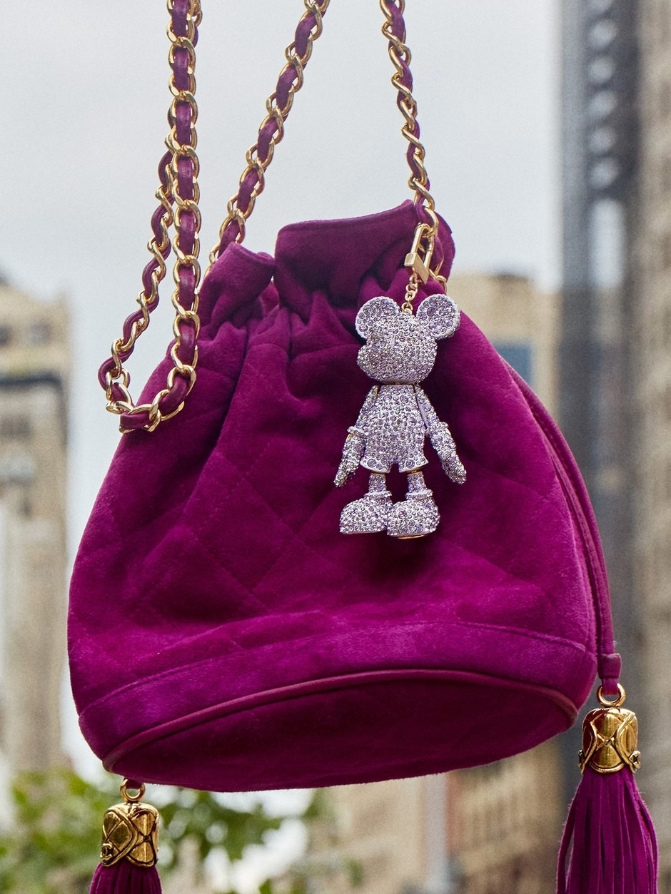 a purple rhinestone mickey keychain on a bag
