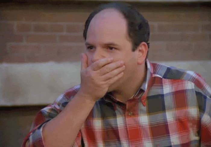 shocked jason alexander covering his mouth