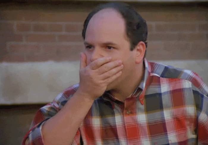 Shocked Jason Alexander covering his mouth