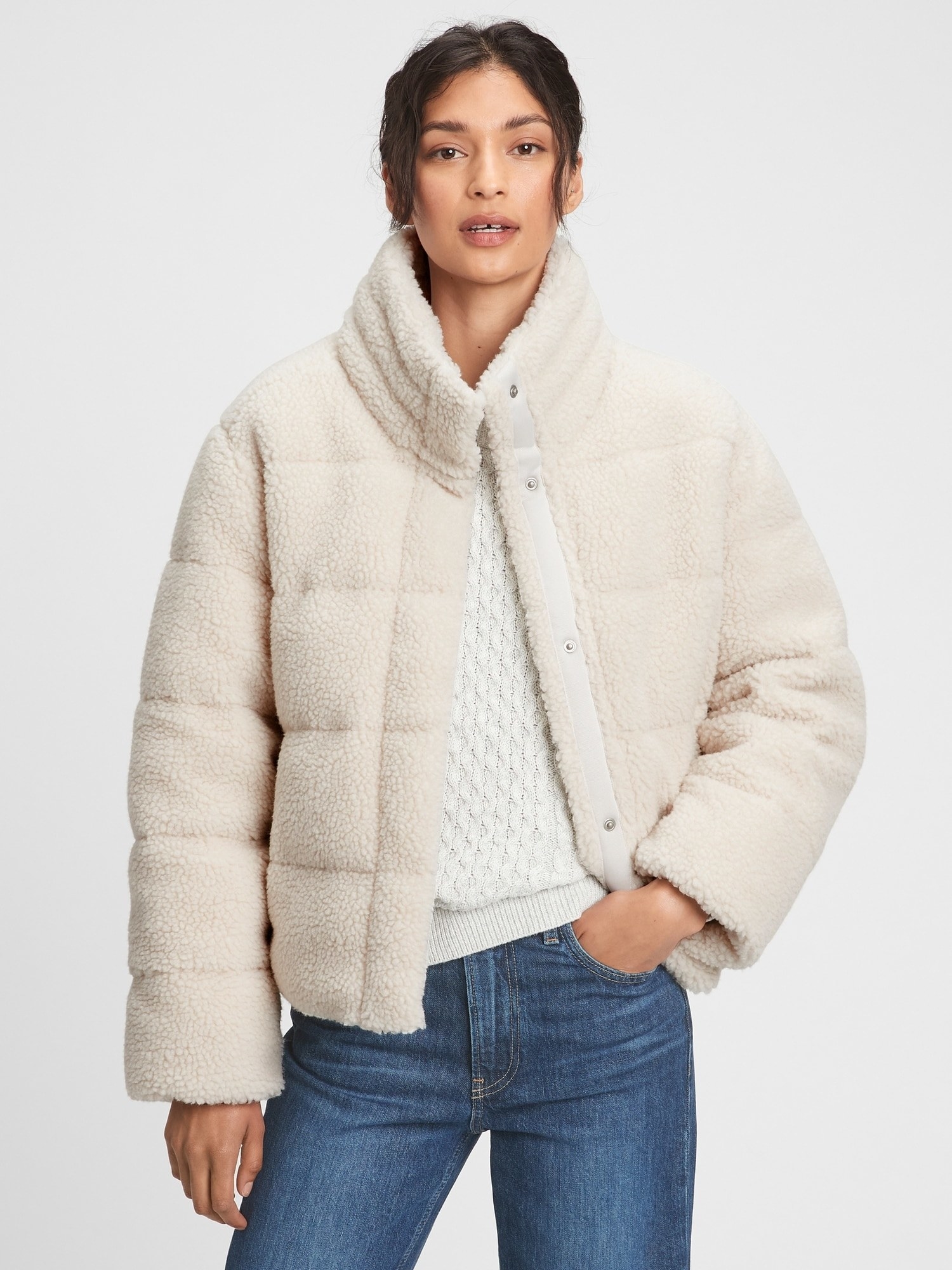 model in a white sherpa jacket