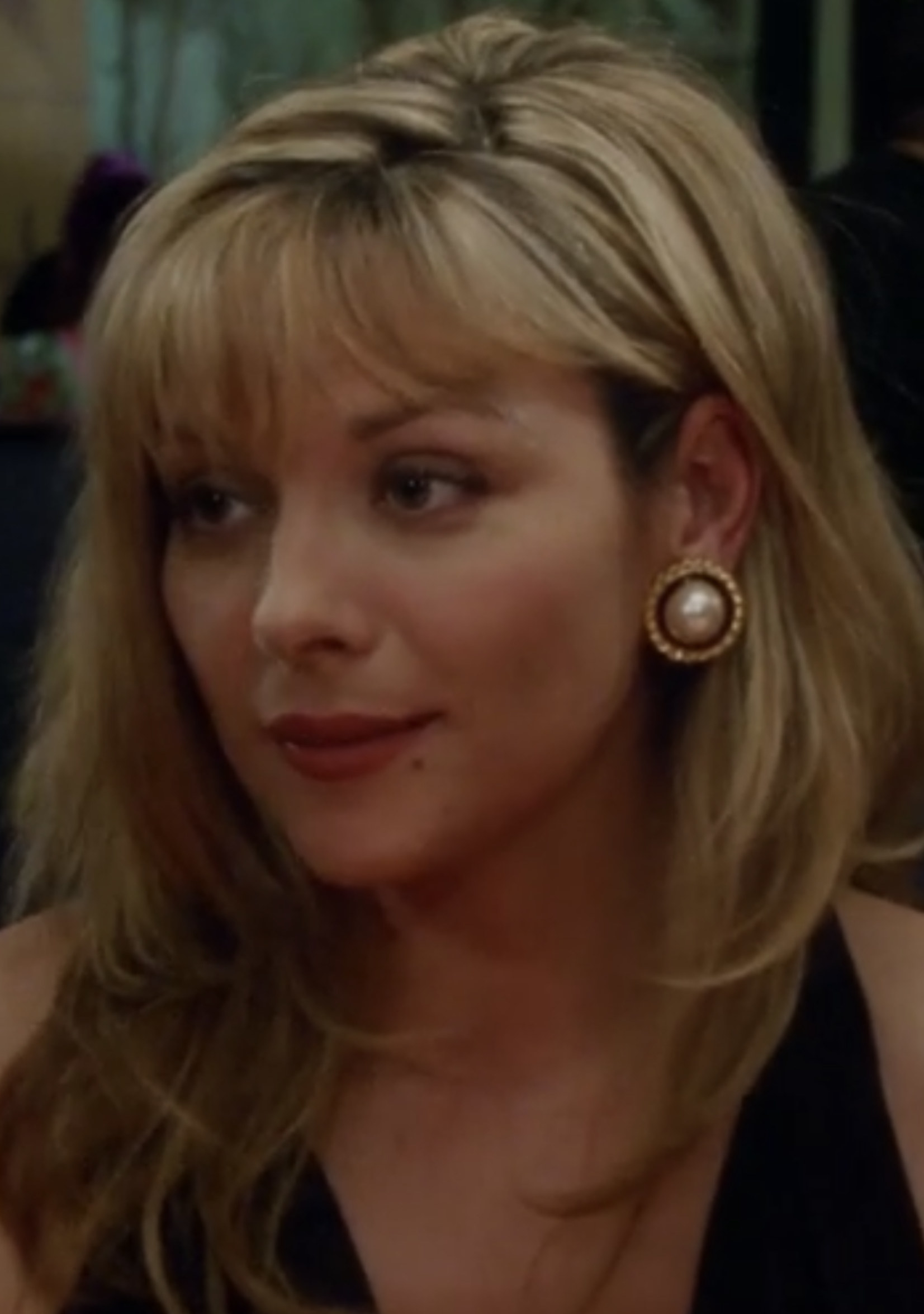 Cattrall wearing a black dress and lipstick in the pilot episode