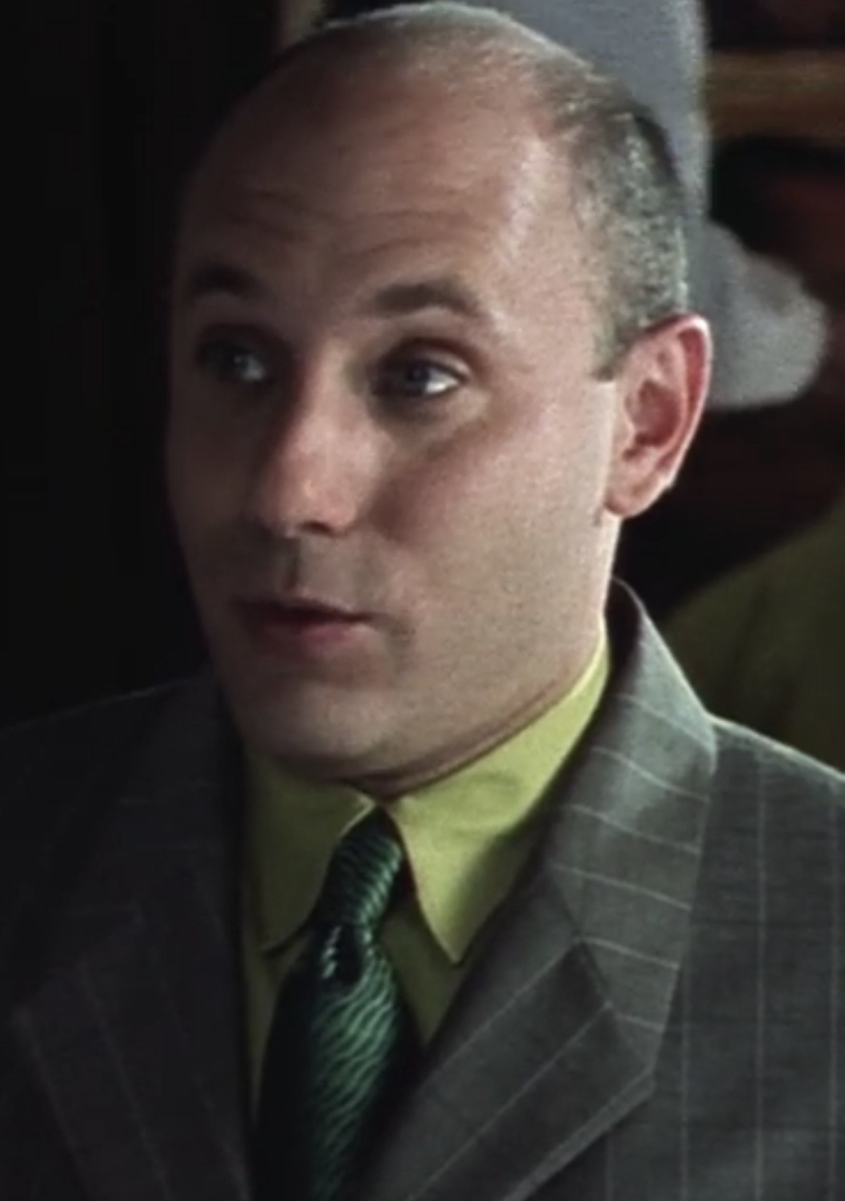 Garson wearing a suit and tie in the pilot episode