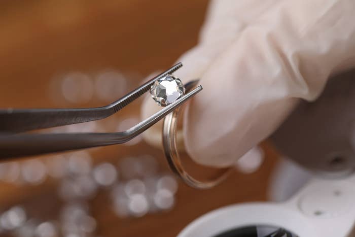 A jeweler installing loose cut moissanite.