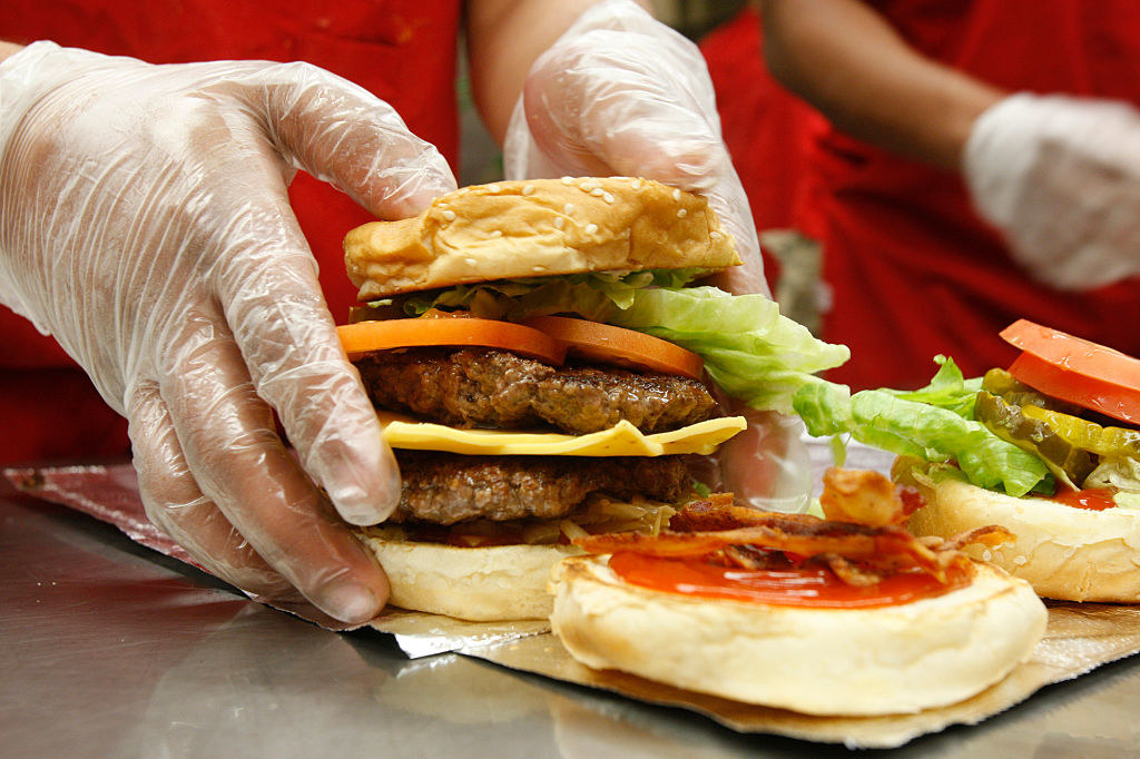 Cheeseburgers being assembled.