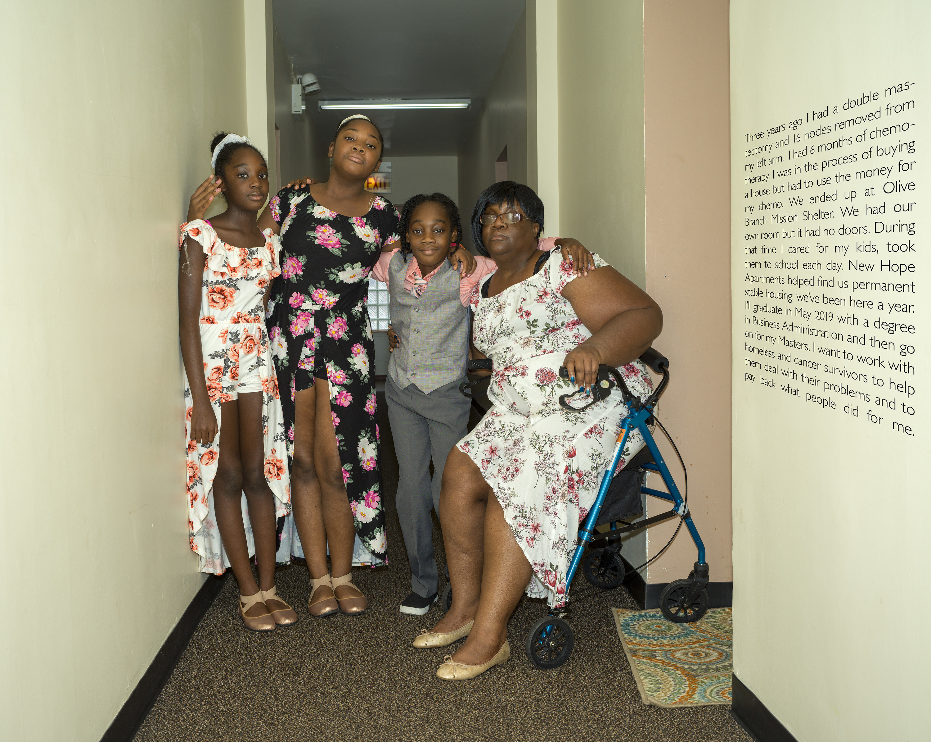 Four women and girls stand in a hallway