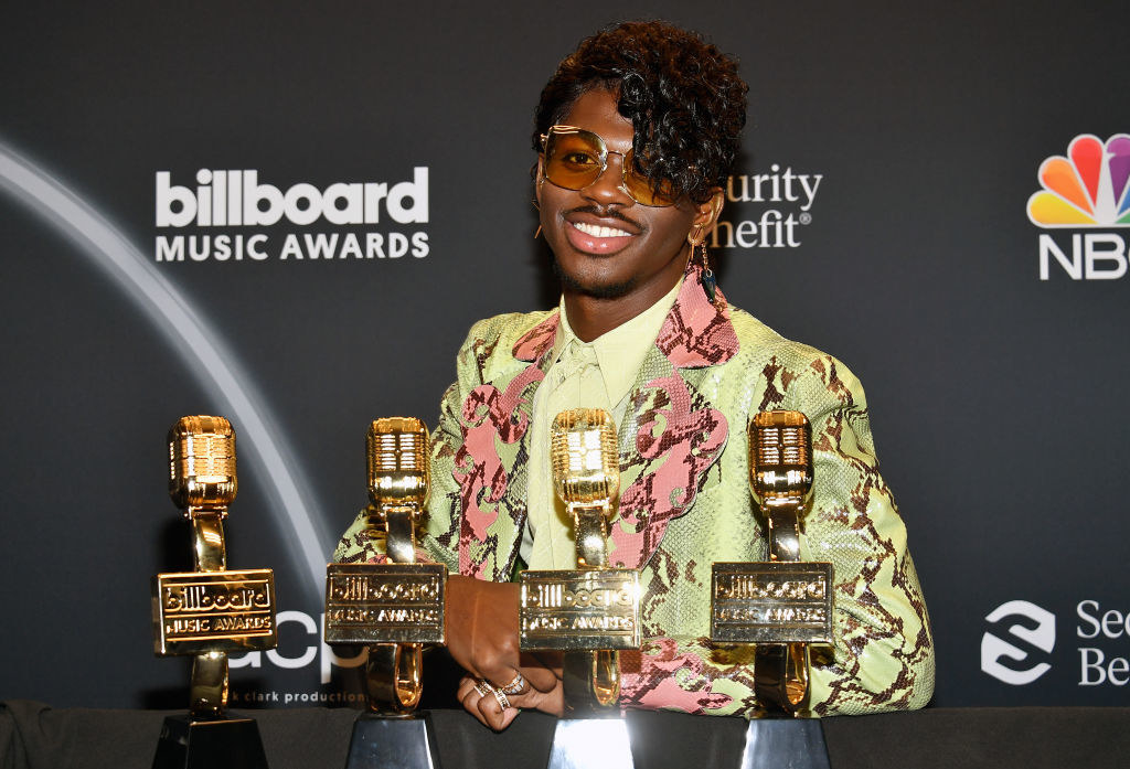 picture of man with four awards in front of him