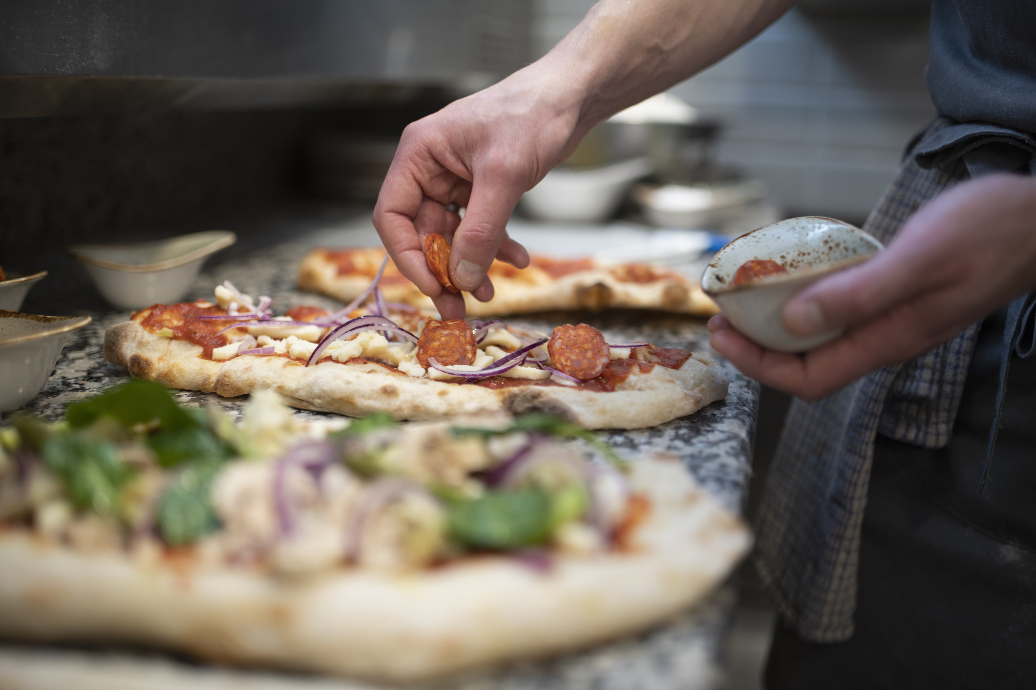 A chef making pizza.