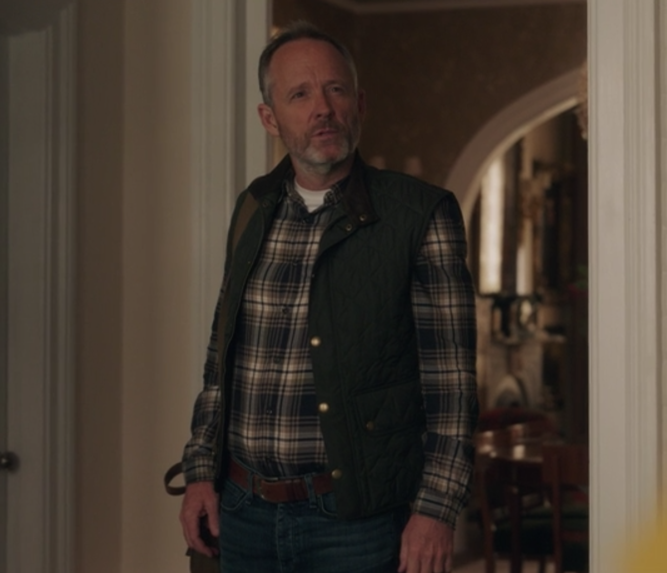 Roy Sachs wears a flannel shirt under a vest and jeans