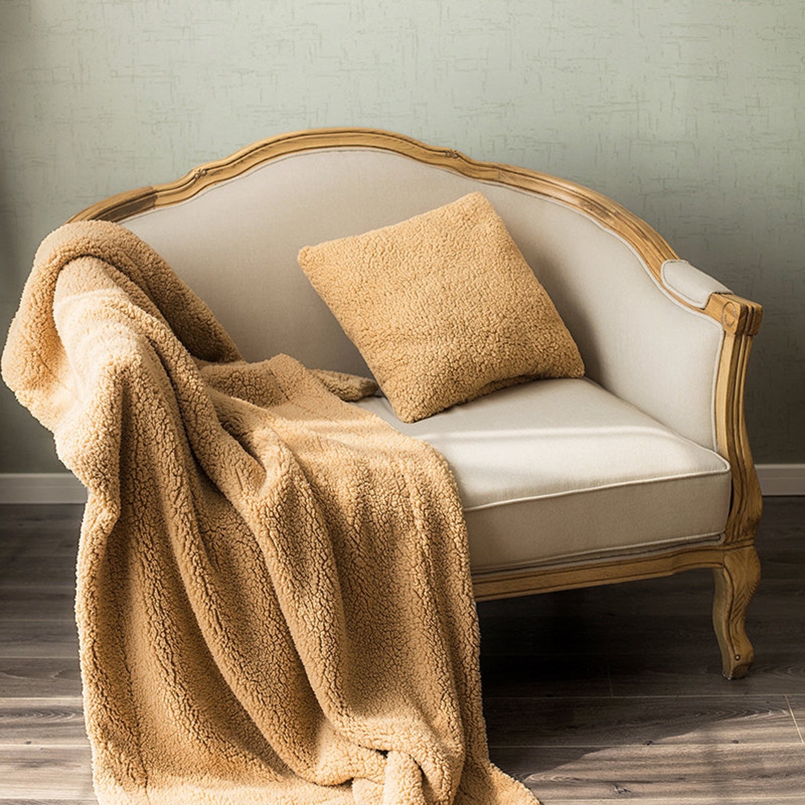 A mustard yellow blanket and pillow on a chair