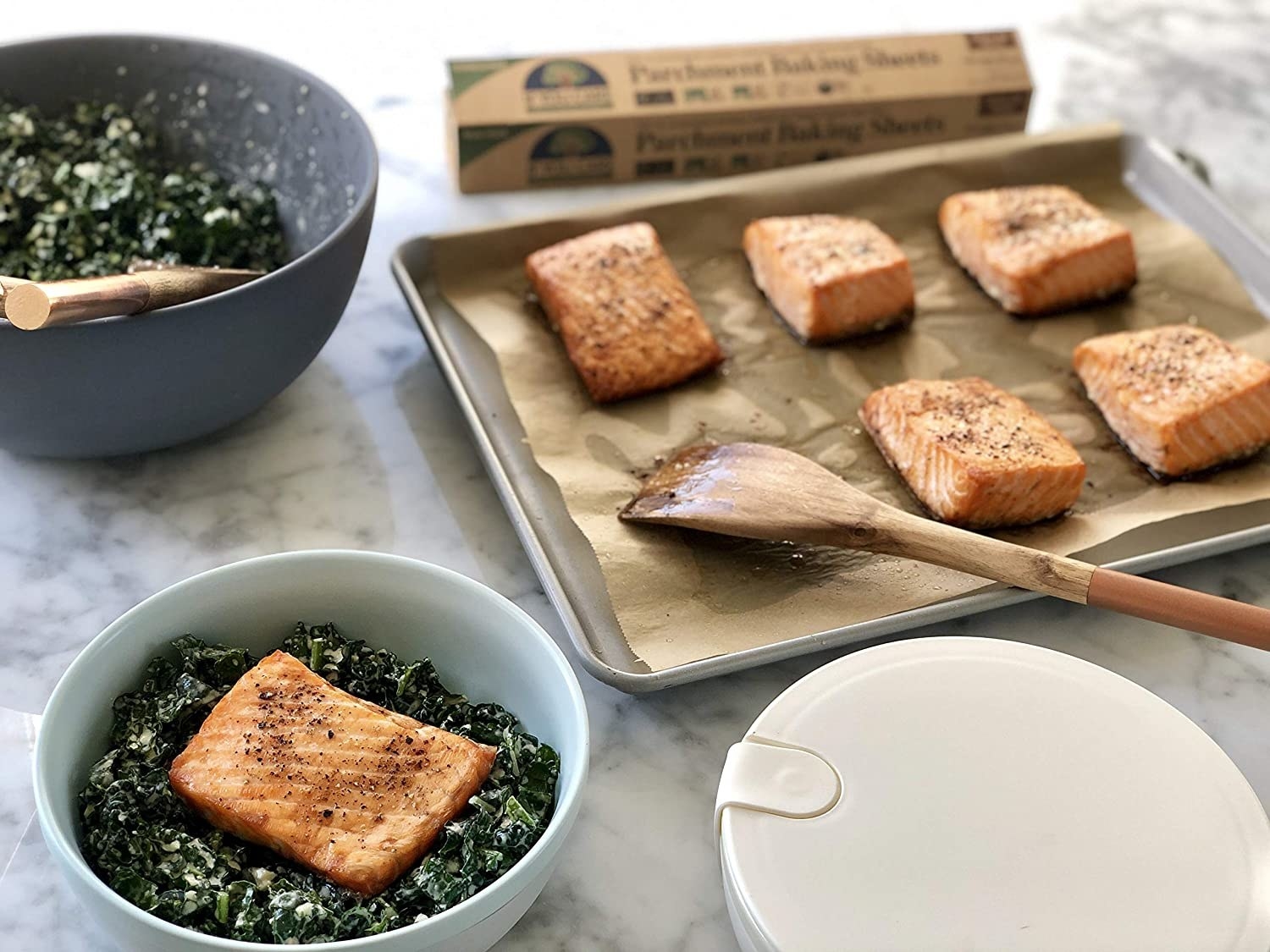 cuts of baked salmon on the parchment paper