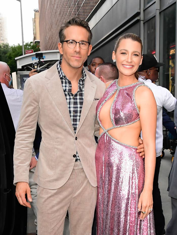 The couple posing for a photo with their arm around each other