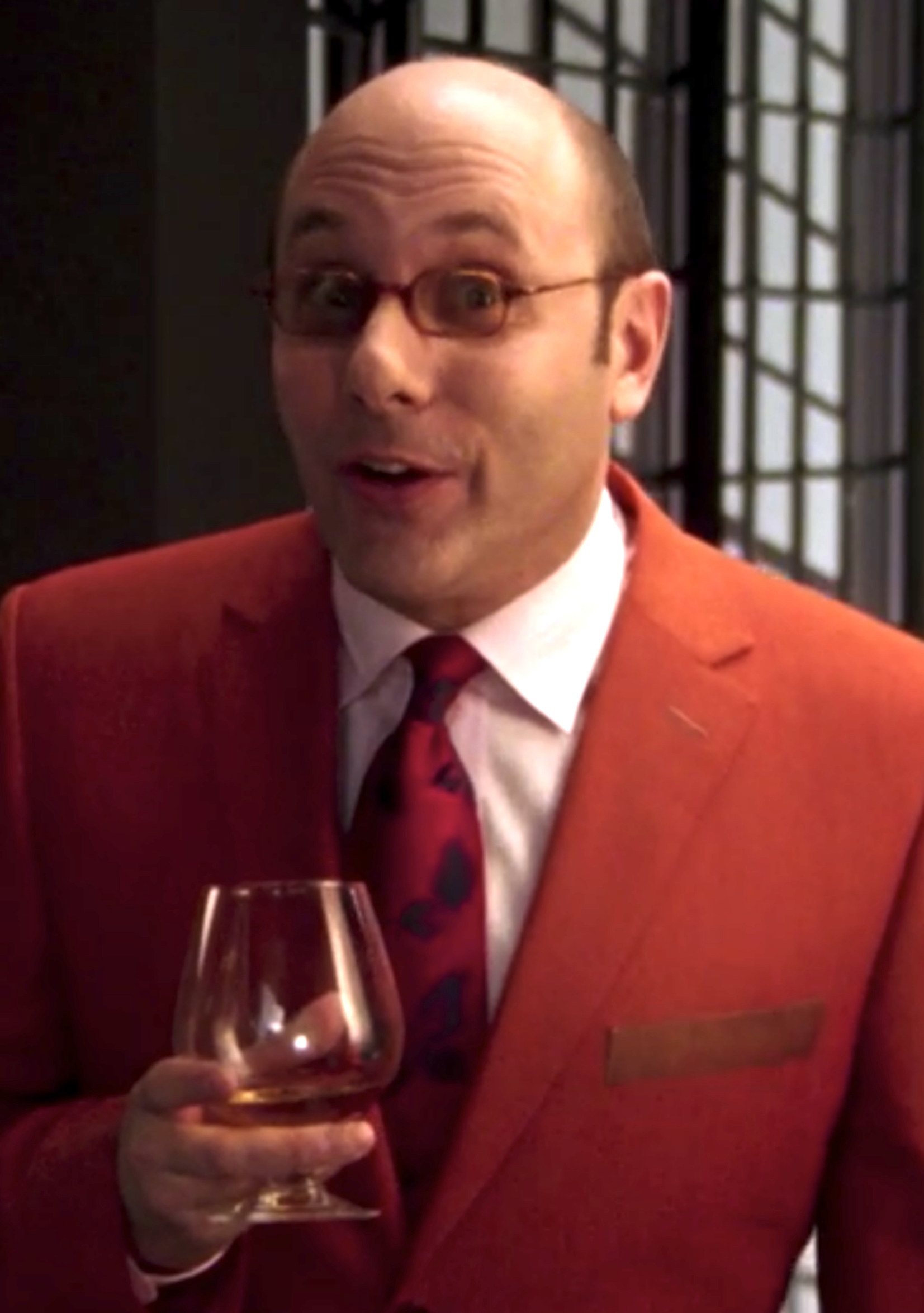 Garson wearing a bright-colored suit and glasses in his last episode of the series