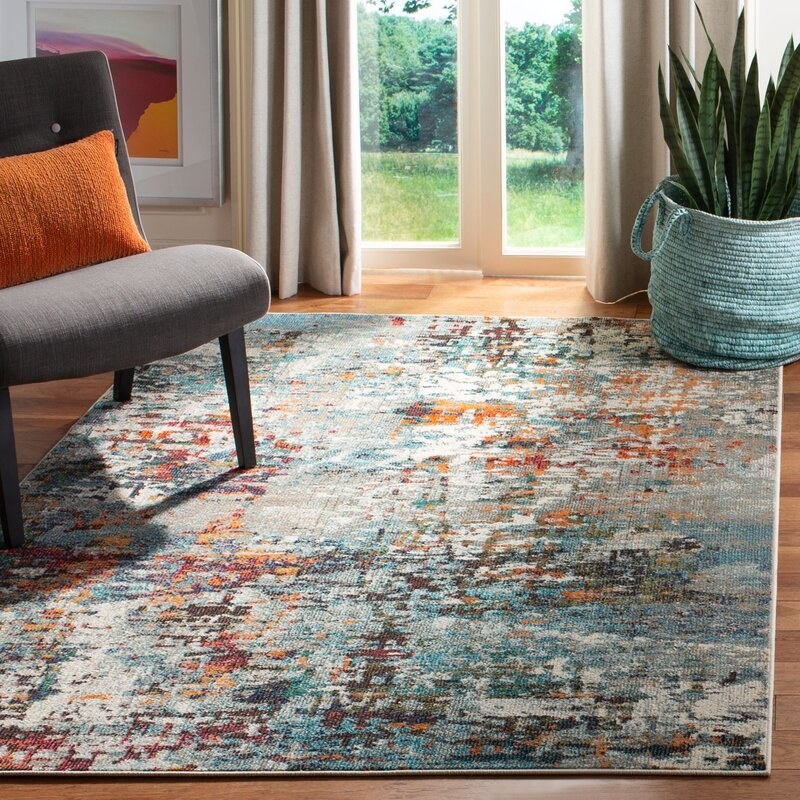 The area rug in a living room next to an open window